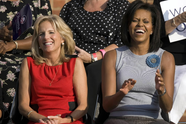 Michelle Obama and Jill Biden laugh together.