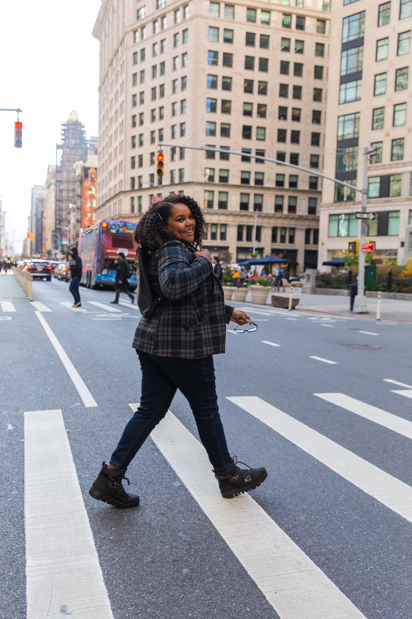 Patranila walks across 5th avenue in her fall fashion uniform. A blazer, slim denim, and comfy shoes.