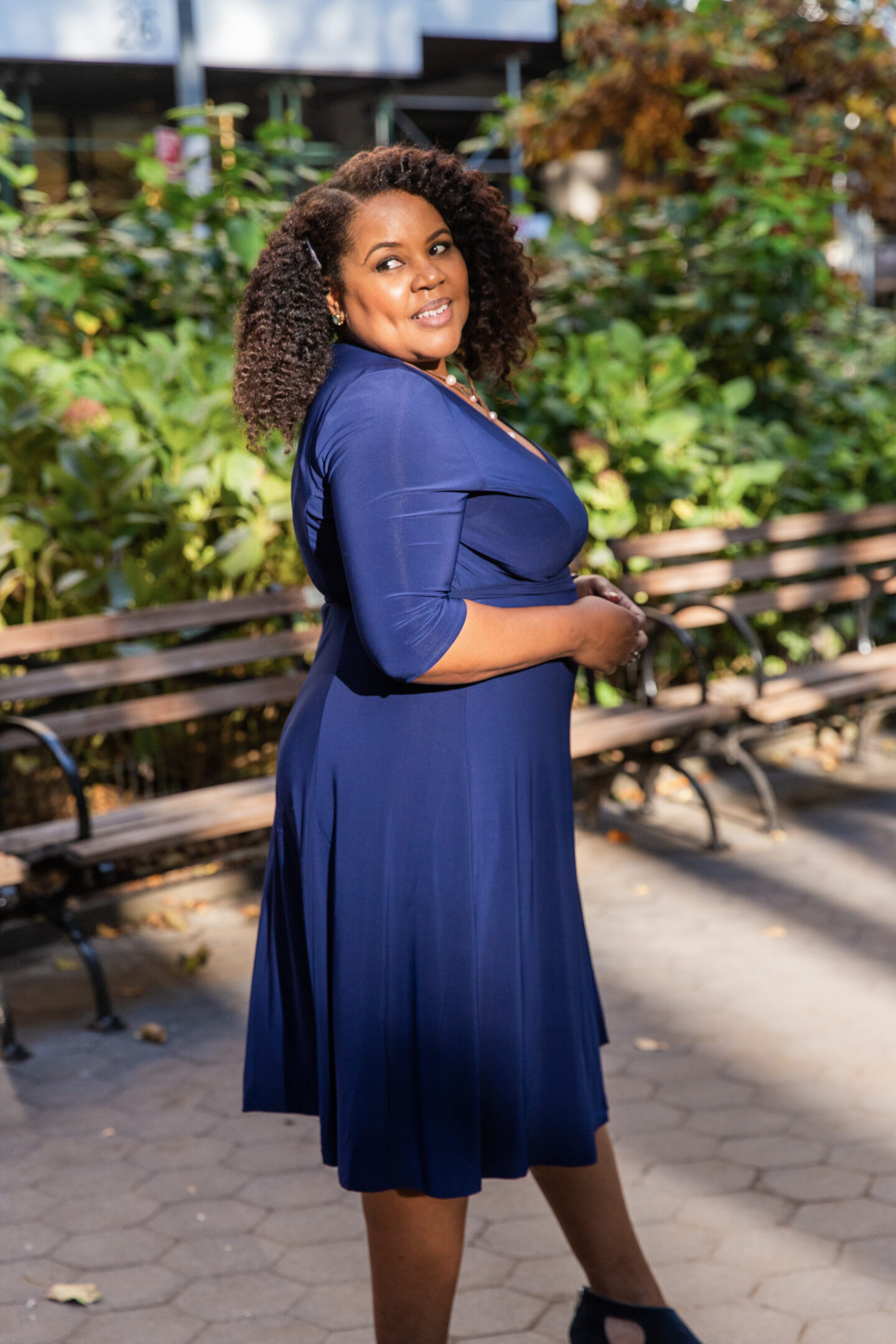 patranila wears kiyonna essential wrap dress in nouveau navy