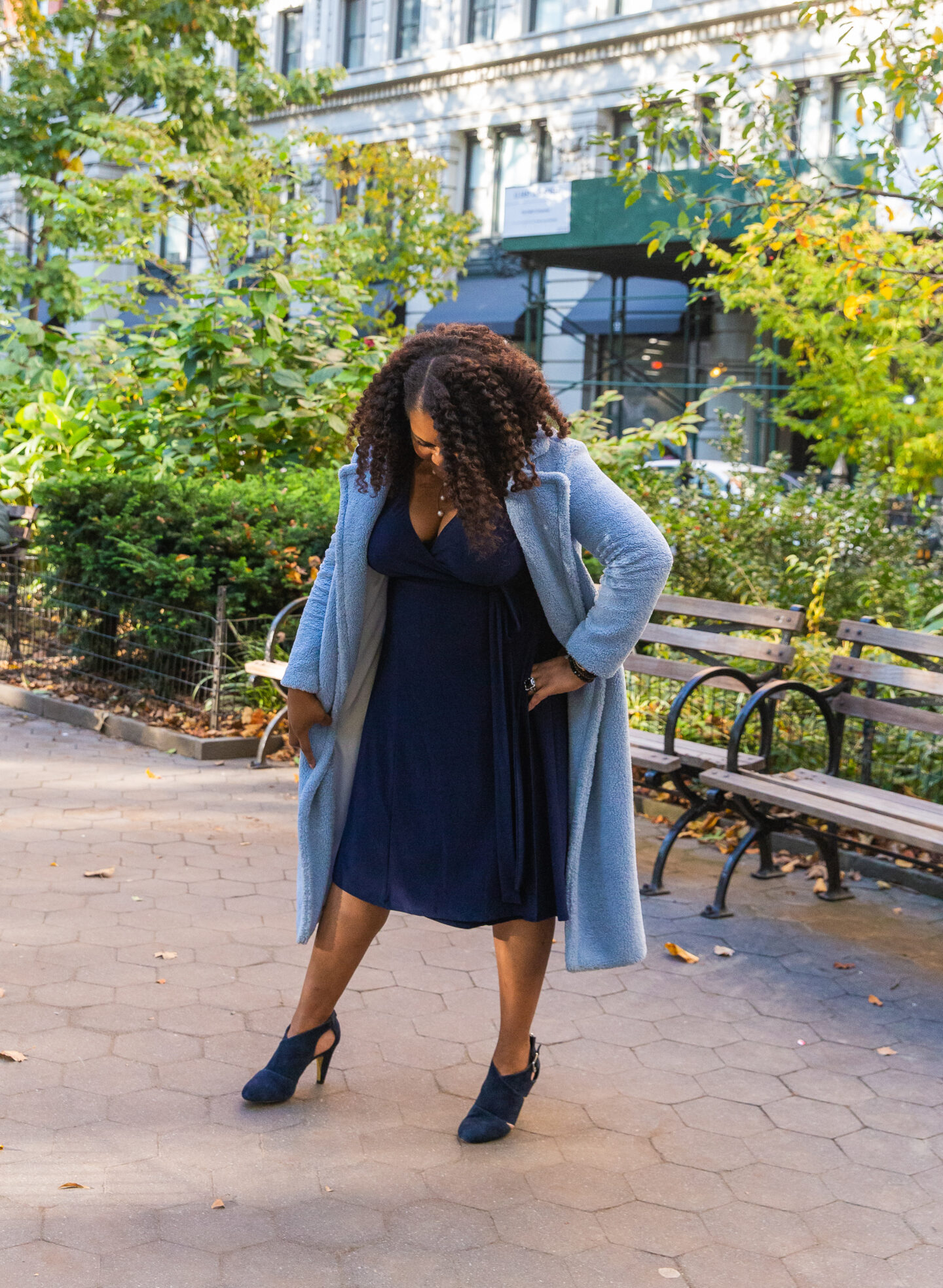 patranila wears blue wrap dress by kiyonna and blue teddy coat by something navy