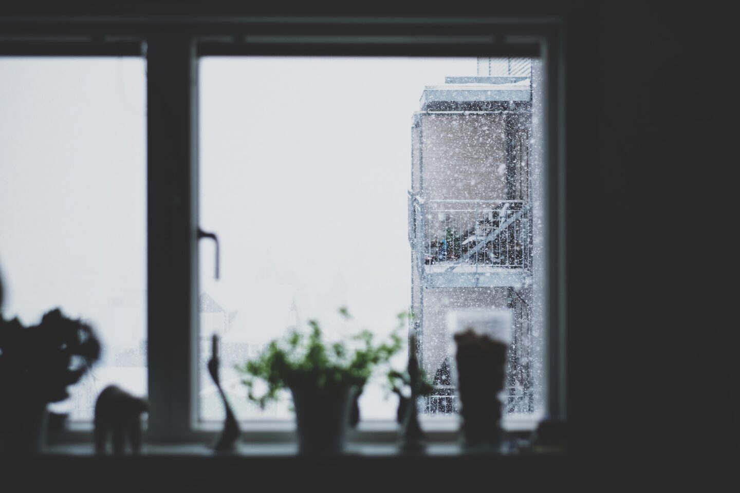 snow falling outside a window