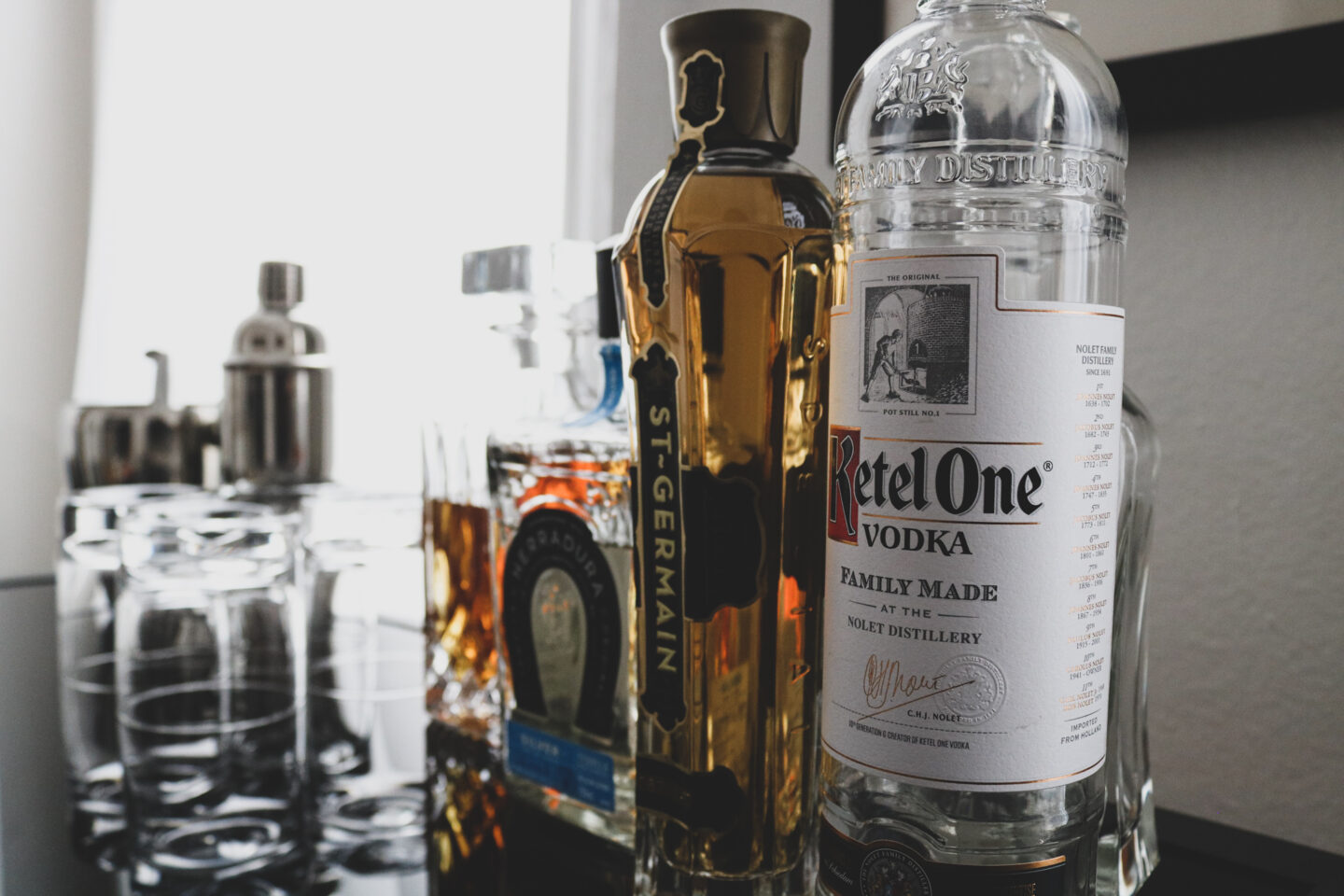 liquor bottles sit atop home bar cart