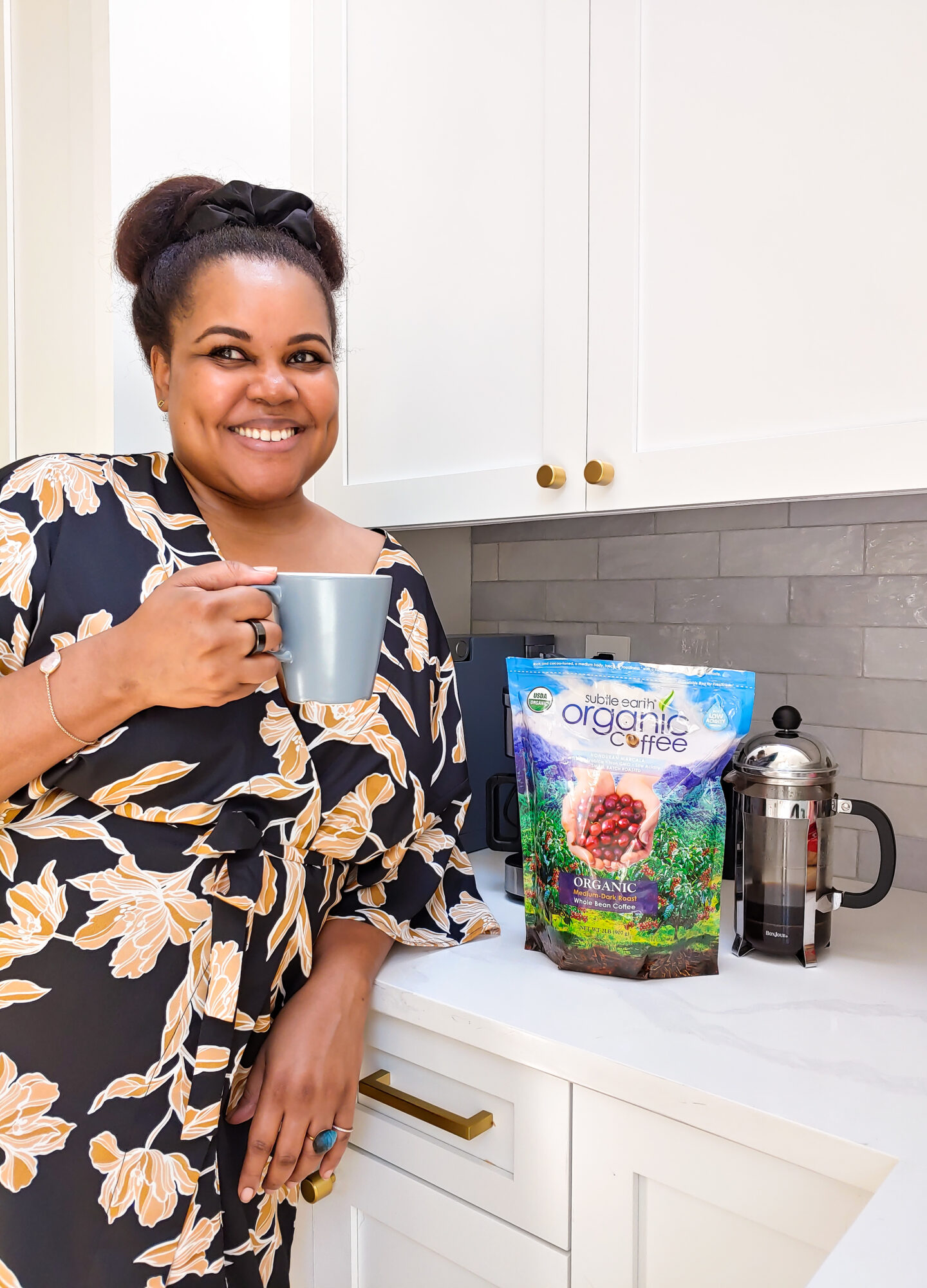 black woman smiling with coffee up