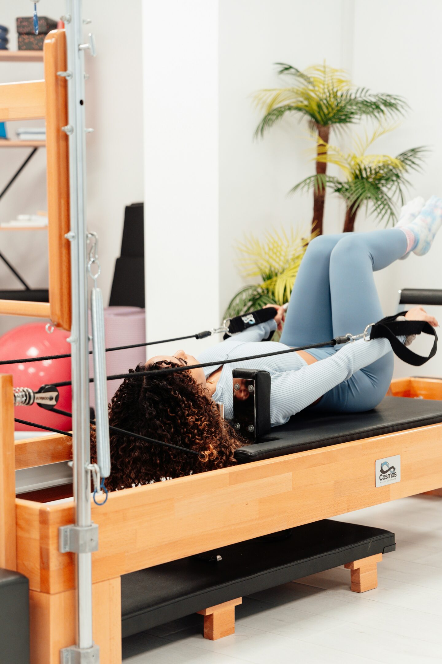 woman working out on a Pilates reformer