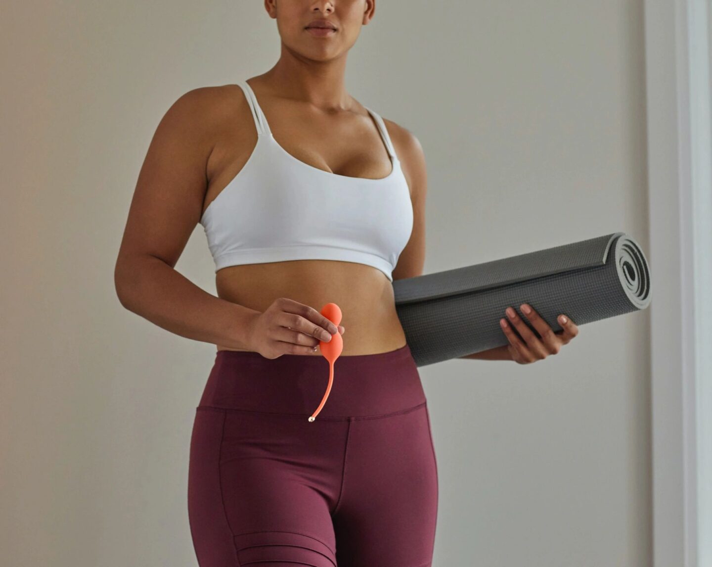 woman holding yoga mat