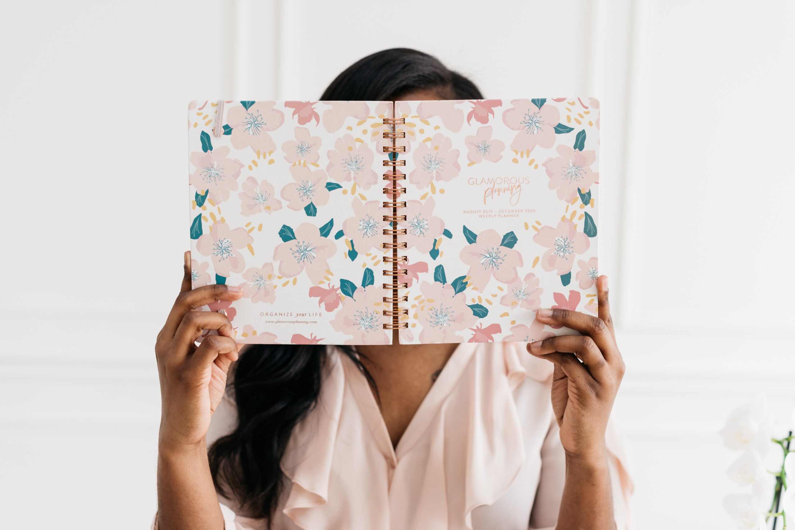 woman holding a planner - how to create new habits