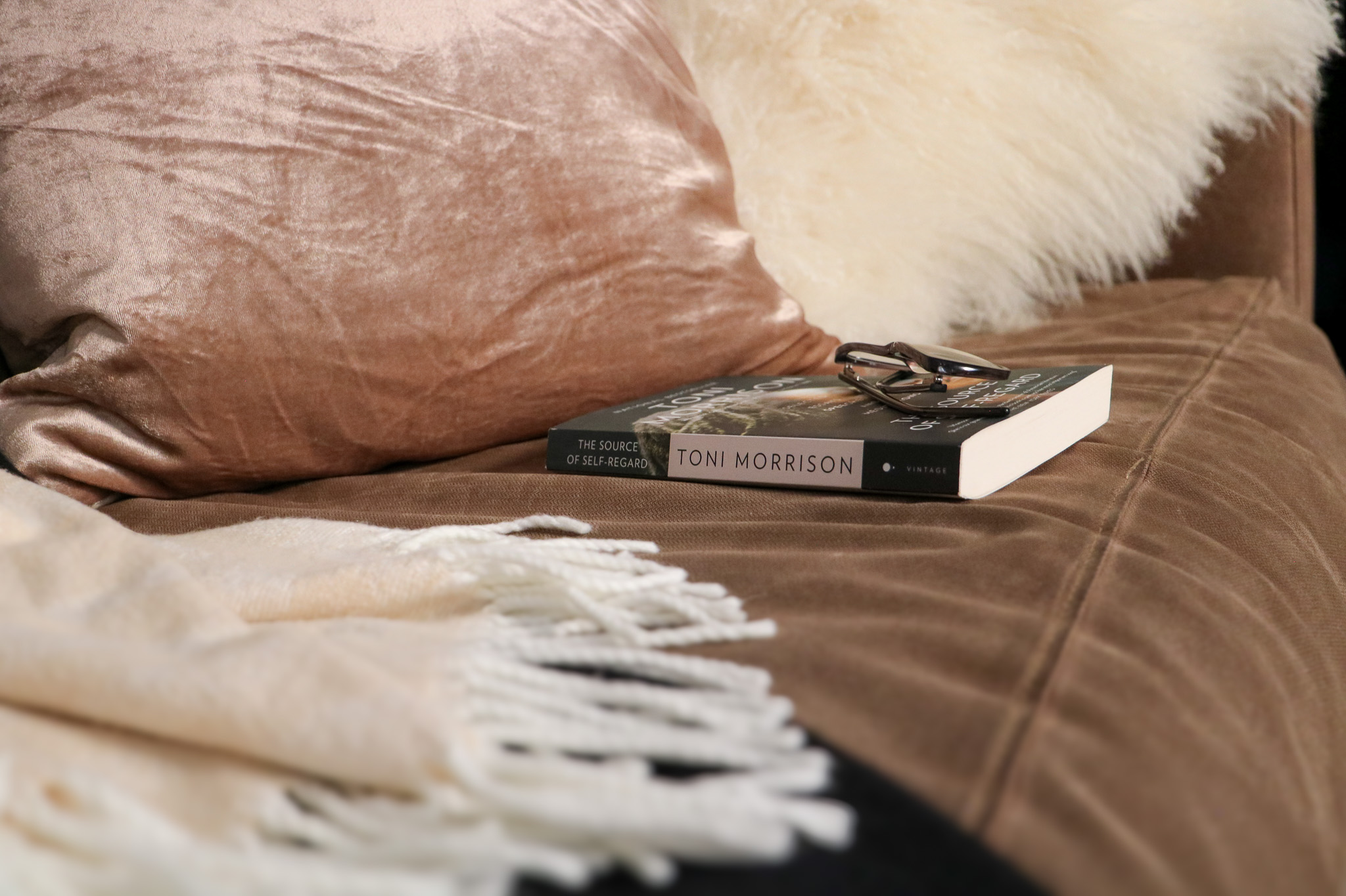 book resting on a cozy sofa