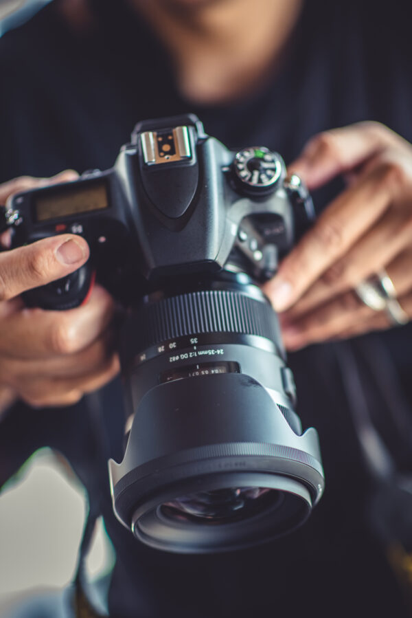 photographer adjusting settings on a DSLR camera